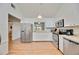 Bright kitchen features stainless steel appliances, white cabinetry, and tile flooring at 7926 Woodpointe Ct # 29, Sarasota, FL 34238
