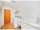 Bright Laundry room with a side-by-side washer and dryer, utility sink and white cabinetry at 7926 Woodpointe Ct # 29, Sarasota, FL 34238