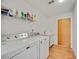 A view of the laundry room featuring side-by-side washer and dryer and an included utility sink at 7926 Woodpointe Ct # 29, Sarasota, FL 34238