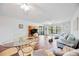 Bright living area with wood-look flooring, neutral decor, and scenic views through large window at 7926 Woodpointe Ct # 29, Sarasota, FL 34238