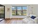 Bright living room featuring a large window overlooking the water view at 7926 Woodpointe Ct # 29, Sarasota, FL 34238