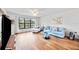Bright living room featuring wood-look flooring, natural light, and cozy seating arrangement at 7926 Woodpointe Ct # 29, Sarasota, FL 34238