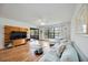 Bright living room with wood floors, ceiling fan, and entertainment center at 7926 Woodpointe Ct # 29, Sarasota, FL 34238