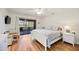 Bright main bedroom with access to a screened-in patio overlooking a lake at 7926 Woodpointe Ct # 29, Sarasota, FL 34238