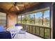 A view of a patio showing the outdoor furniture, wooden ceiling and view of the lake at 7926 Woodpointe Ct # 29, Sarasota, FL 34238