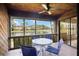 Inviting screened patio with lake view, ceiling fan, and cozy seating area, perfect for relaxing outdoors at 7926 Woodpointe Ct # 29, Sarasota, FL 34238