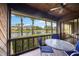 Inviting screened patio with lake view, ceiling fan, and cozy seating area, perfect for relaxing outdoors at 7926 Woodpointe Ct # 29, Sarasota, FL 34238