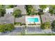 Overhead view of a refreshing community pool surrounded by lounge chairs and manicured landscaping at 7926 Woodpointe Ct # 29, Sarasota, FL 34238