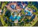 Stunning aerial view of a luxury community featuring multiple pools, lush landscaping, and beautiful architecture at 8218 Genoa Blvd, Lakewood Ranch, FL 34202