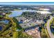 Aerial view of tennis courts and a beautiful lake in a private community at 8218 Genoa Blvd, Lakewood Ranch, FL 34202