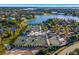 Aerial view of tennis courts and a beautiful lake in a private community at 8218 Genoa Blvd, Lakewood Ranch, FL 34202