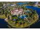 A luxury community clubhouse with pools, palm trees, and is surrounded by water and tennis courts at 8218 Genoa Blvd, Lakewood Ranch, FL 34202