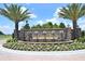 Welcoming stone entrance of The Lake Club with water feature and lush landscaping at 8218 Genoa Blvd, Lakewood Ranch, FL 34202