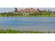 Stunning waterfront views showcasing an estate home with lush landscaping and private lake access at 8218 Genoa Blvd, Lakewood Ranch, FL 34202