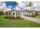 Elegant two-story home with a paved driveway, lush landscaping, and a three-car garage at 8218 Genoa Blvd, Lakewood Ranch, FL 34202