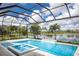 Screened in pool area and spa with a waterfall feature overlooking a beautiful lake at 8218 Genoa Blvd, Lakewood Ranch, FL 34202