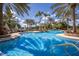 Beautiful swimming pool with palm trees, lounge chairs, and clear blue water perfect for relaxation and recreation at 8218 Genoa Blvd, Lakewood Ranch, FL 34202