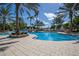 Luxurious swimming pool surrounded by palm trees, lounge chairs, and a spacious deck for sunbathing and relaxation at 8218 Genoa Blvd, Lakewood Ranch, FL 34202