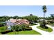Aerial view showcasing the house, screened pool, luscious landscaping, and curving driveway at 9102 12Th Nw Ave, Bradenton, FL 34209