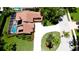 Aerial view of the home with a screened in pool, manicured landscaping, and long driveway at 9102 12Th Nw Ave, Bradenton, FL 34209