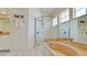 Elegant bathroom featuring a glass-enclosed shower, soaking tub, and decorative accents at 9102 12Th Nw Ave, Bradenton, FL 34209
