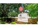 Hawthorn Park community sign with an American flag surrounded by lush greenery at 9102 12Th Nw Ave, Bradenton, FL 34209