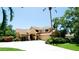 Charming two-story home featuring a lush landscaped yard, circular driveway, and a welcoming front entrance at 9102 12Th Nw Ave, Bradenton, FL 34209