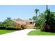 Inviting two-story home featuring a well-manicured lawn, circular driveway, mature trees and attractive front entrance at 9102 12Th Nw Ave, Bradenton, FL 34209