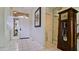 Inviting foyer features tile flooring, decorative clock, and views to the powder room at 9102 12Th Nw Ave, Bradenton, FL 34209