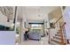 Bright foyer with stairs leading upstairs and views to the pool out the windows at 9102 12Th Nw Ave, Bradenton, FL 34209