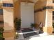 Inviting front entrance with tan walls, decorative columns, storm door, and plants at 9102 12Th Nw Ave, Bradenton, FL 34209