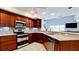 Well-lit kitchen with granite countertops, stainless steel appliances, and dark wood cabinetry at 9102 12Th Nw Ave, Bradenton, FL 34209