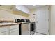 Functional laundry room with stainless steel washer/dryer, sink, and ample cabinet space at 9102 12Th Nw Ave, Bradenton, FL 34209