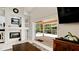 Bright living room with fireplace, built-in shelving, and access to an outdoor patio and pool at 9102 12Th Nw Ave, Bradenton, FL 34209