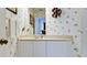Cozy powder room featuring vanity with a neutral countertop and patterned wallpaper at 9102 12Th Nw Ave, Bradenton, FL 34209