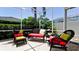Relaxing screened patio with wicker furniture, colorful cushions, and lush green landscaping at 9102 12Th Nw Ave, Bradenton, FL 34209