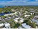 High-altitude view featuring a community with serene pond, lined with trees, offering a tranquil lifestyle at 101 Whispering Sands Dr # 307, Sarasota, FL 34242