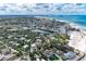 Picturesque aerial view of a coastal community with a sandy beach, homes, and ocean at 101 Whispering Sands Dr # 307, Sarasota, FL 34242