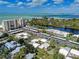 Aerial view featuring condos and homes along a beautiful waterfront with lush greenery at 101 Whispering Sands Dr # 307, Sarasota, FL 34242
