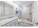 Clean bathroom with granite vanity, glass-enclosed shower, and modern fixtures at 101 Whispering Sands Dr # 307, Sarasota, FL 34242