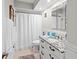 Clean bathroom featuring a granite vanity, framed mirror, shower, toilet, and tiled flooring at 101 Whispering Sands Dr # 307, Sarasota, FL 34242