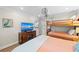 This bedroom boasts a TV, bunk beds, and outdoor access, providing entertainment and convenience at 101 Whispering Sands Dr # 307, Sarasota, FL 34242