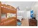 The bedroom features a TV, bunk beds, and wood-look flooring for a cozy and functional space at 101 Whispering Sands Dr # 307, Sarasota, FL 34242