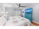 Bright bedroom with decorative fan, coastal decor, and flat-screen TV at 101 Whispering Sands Dr # 307, Sarasota, FL 34242