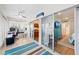 Bright sunroom with a ceiling fan, desk, and access to bedroom with bunkbeds and a view of the living room at 101 Whispering Sands Dr # 307, Sarasota, FL 34242