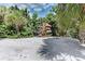 Beachside boat storage with multiple racks for canoes and kayaks among lush greenery at 101 Whispering Sands Dr # 307, Sarasota, FL 34242