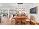 Inviting dining area with a modern light fixture, seamlessly connects to a bright balcony for indoor/outdoor enjoyment at 101 Whispering Sands Dr # 307, Sarasota, FL 34242