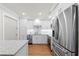 This kitchen with stainless appliances, white cabinetry, and wood floors is designed with modern elegance in mind at 101 Whispering Sands Dr # 307, Sarasota, FL 34242