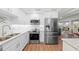 Updated kitchen features stainless steel appliances and white cabinets, conveniently open to adjacent living spaces at 101 Whispering Sands Dr # 307, Sarasota, FL 34242
