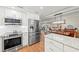 Light-filled kitchen boasts stainless steel appliances and stone countertops and offers seamless flow into the dining area at 101 Whispering Sands Dr # 307, Sarasota, FL 34242